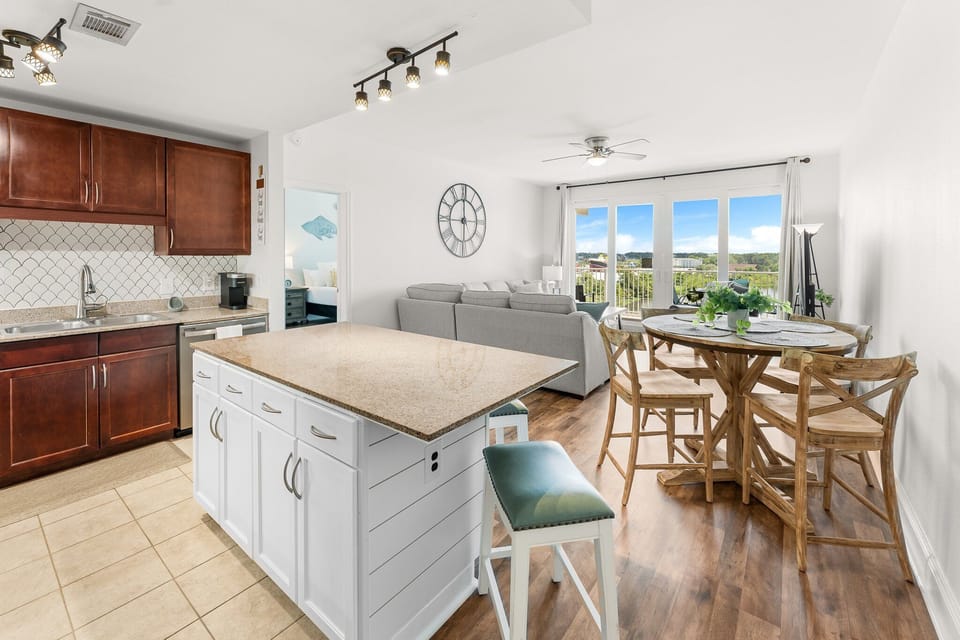 Open-concept kitchen and living area with natural light and balcony views