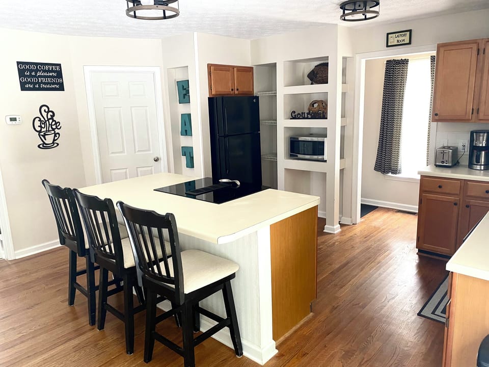 Kitchen island with view to laundry room area (whirlpool top load washer/dryer)