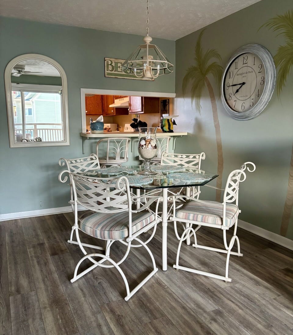 Dine and unwind in this light filled, palm-kissed dining nook.