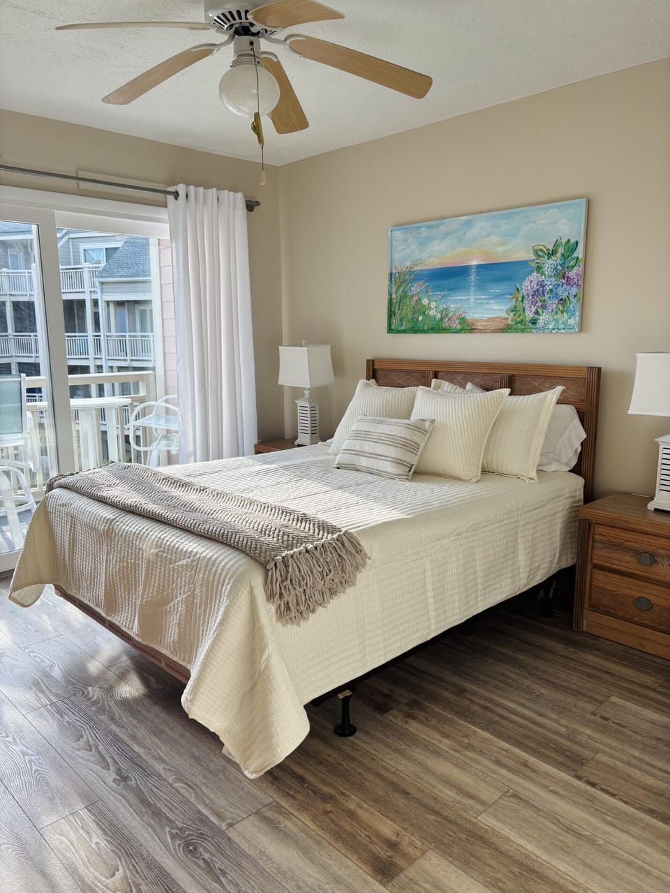 Master bedroom has a cozy queen bed, coastal charm & private ocean view balcony.