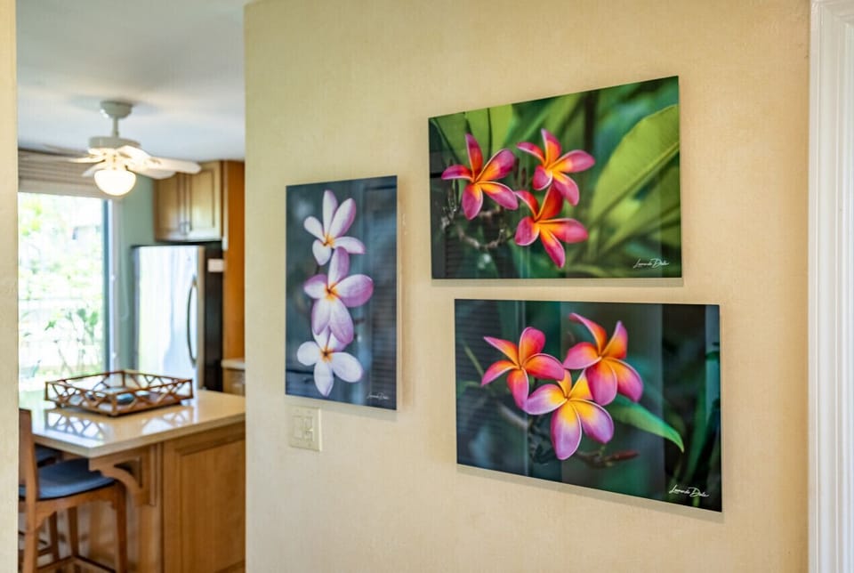 Lush floral prints brighten the hallway w/ pops of tropical color.