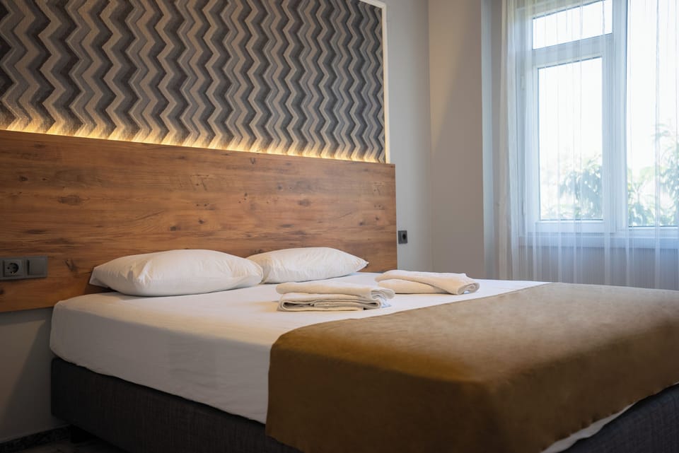 Family Suite, Partial Sea View | Minibar, desk, laptop workspace, free WiFi