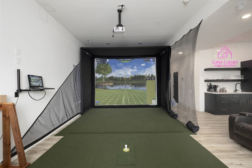 Waterfront Green - Basement Level: Family & Game Room w/ golf simulator, putting green, and pop-a-shot