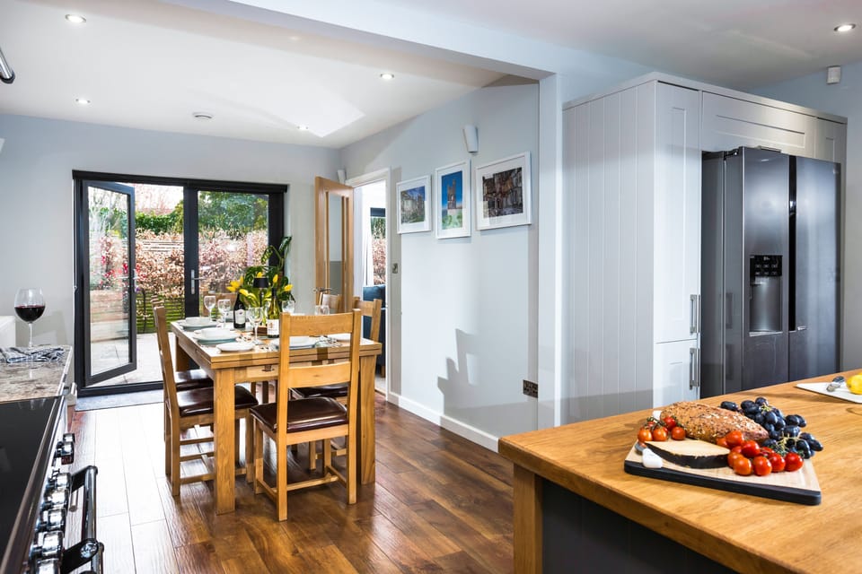 The kitchen overlooks the dining area, with french doors leading to the courtyard