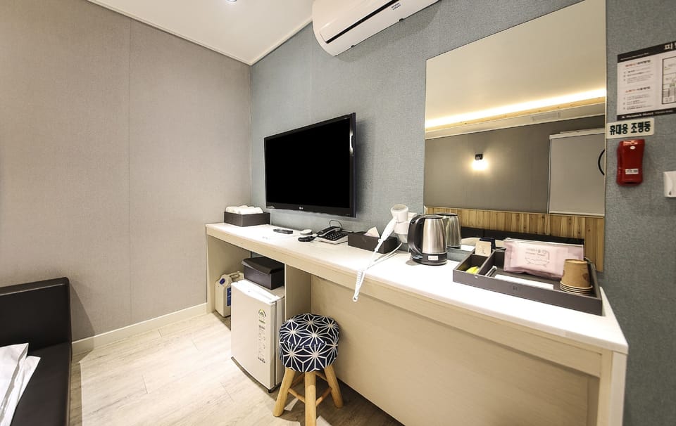 Family Triple Room, City View | Living area | 65-inch LED TV with cable channels, Netflix, heated floors