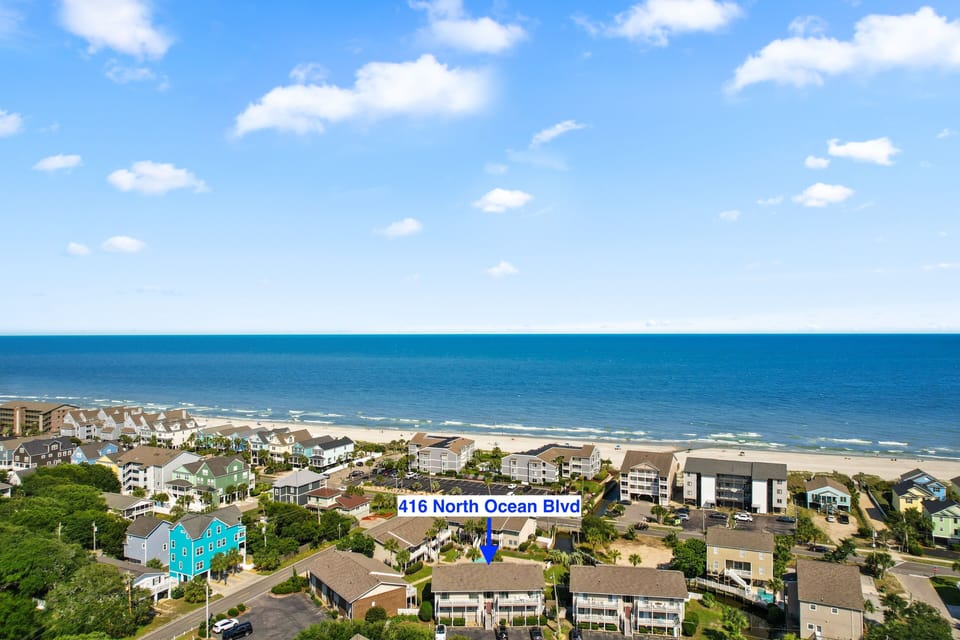 Aerial view of coastal neighborhood, including the highlighted property at 416 North Ocean Blvd, just steps from pristine sandy shores.