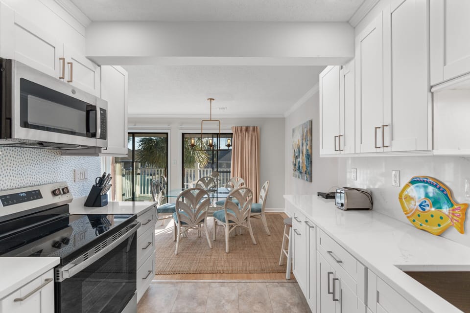 Your fully equipped kitchen flows seamlessly into the dining area, perfect for preparing meals and gathering with loved ones.