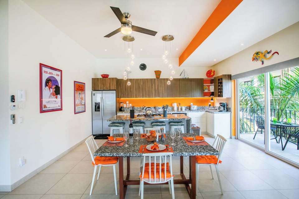 Open-concept kitchen and dining space with bright accents