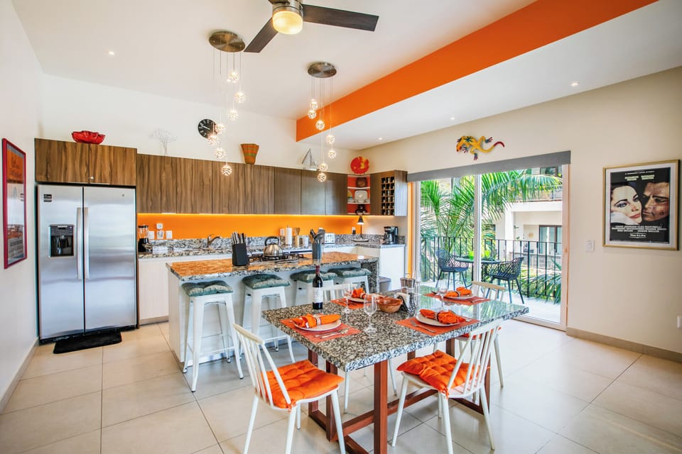 Open-concept kitchen and dining space with bright accents