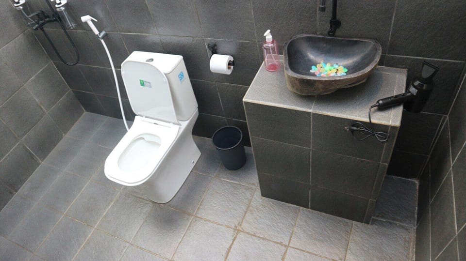 Bungalow, River View | Bathroom | Shower, hair dryer, towels