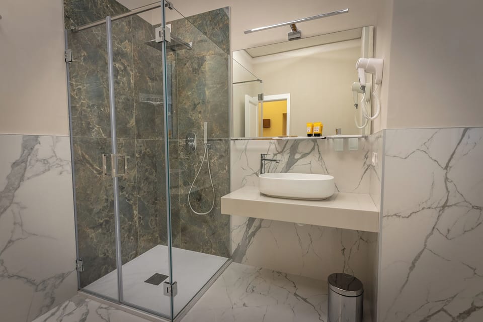 Superior Room, Balcony, City View | Bathroom | Shower, rainfall showerhead, hair dryer, slippers
