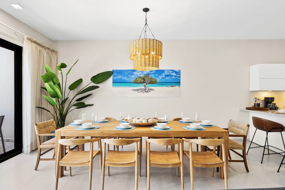 Gather and dine in style at elegant dining area of the apartment in Noord Aruba - Every meal becomes a memorable occasion, featuring dining for 10 persons - Designed for comfort and conviviality with easy access to kitchen and the outdoors