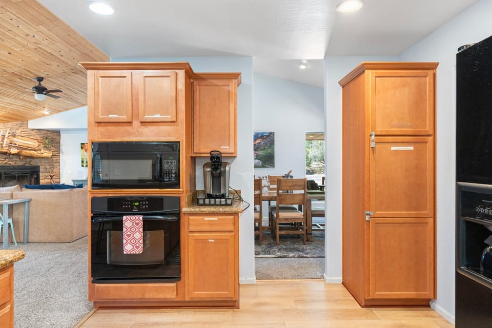 Full-size fridge, microwave, oven, stovetop, and Keurig drip coffee maker. 