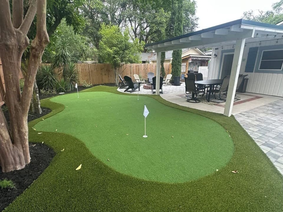 A private, professionally installed backyard putting green, perfect for a casual afternoon.