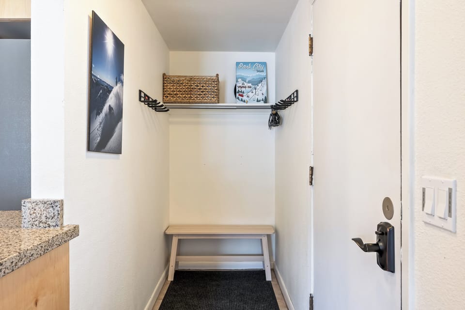 Convenient entry area with bench seating, hooks, and storage—great for jackets, shoes, and gear after a day outside.