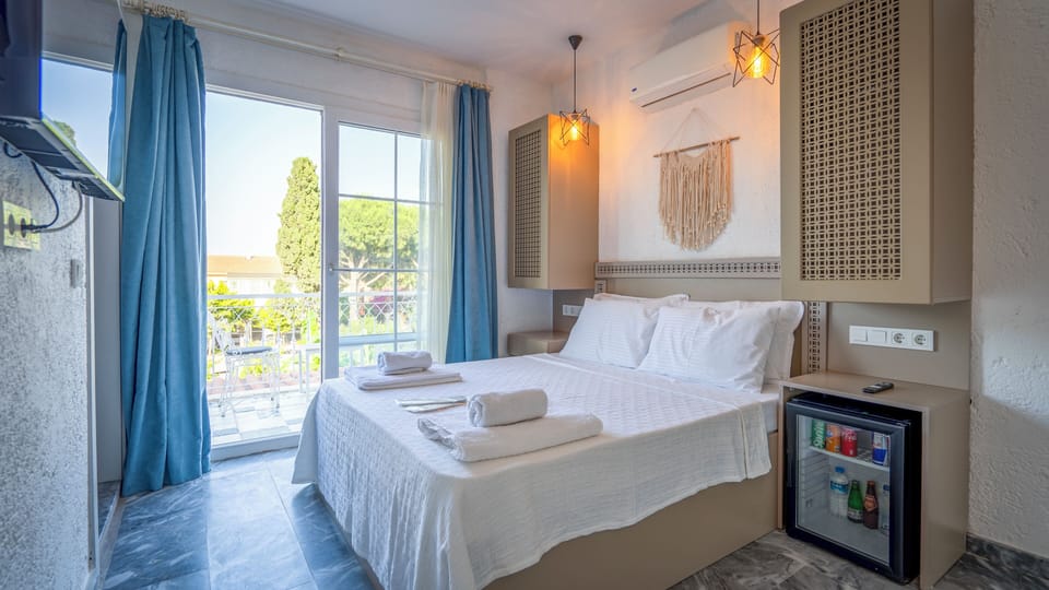 Deluxe Double Room, 1 Queen Bed, Balcony, Pool View | In-room safe, blackout drapes, soundproofing, iron/ironing board