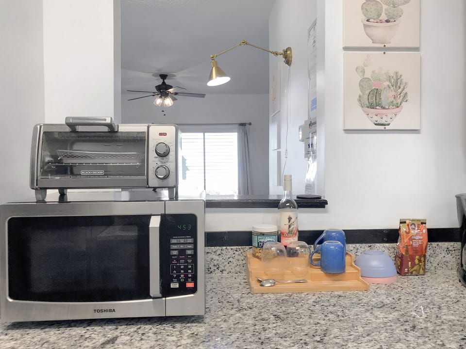 The upgraded kitchen features a stove, oven, microwave, and toaster.  