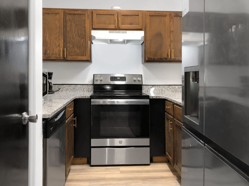 The upgraded kitchen features a stove, oven, microwave, and toaster.  