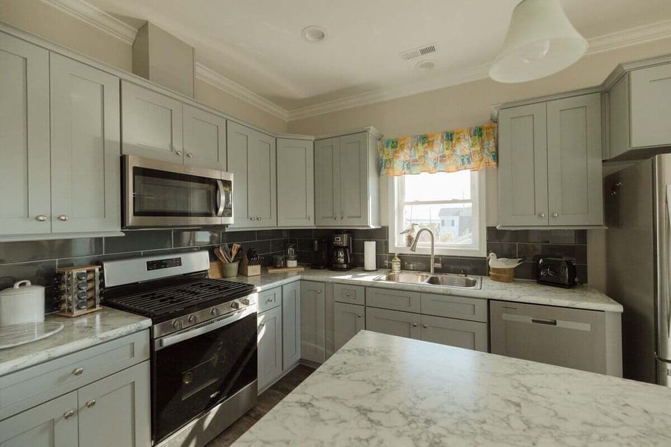 Modern kitchen fully stocked with cookware, appliances, and everything needed for cooking family meals and entertaining guests.