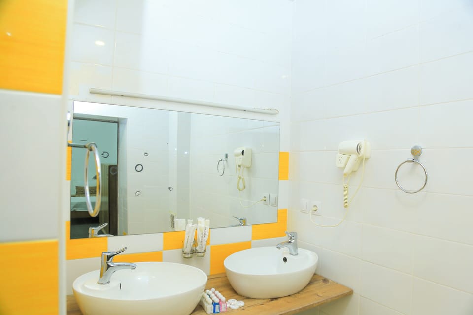 Economy Quadruple Room | Bathroom | Shower, hair dryer, towels, soap