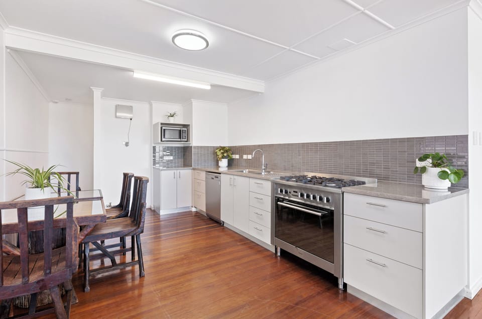 Modern, well appointed kitchen. Large stainless electric oven with gas 6 burner cooktop