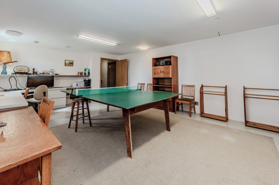 Large recreation room with a ping pong table and lounge area—great for rainy day fun or evening entertainment with family and friends.