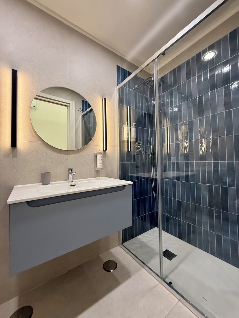 Shower, rainfall showerhead, hair dryer, towels