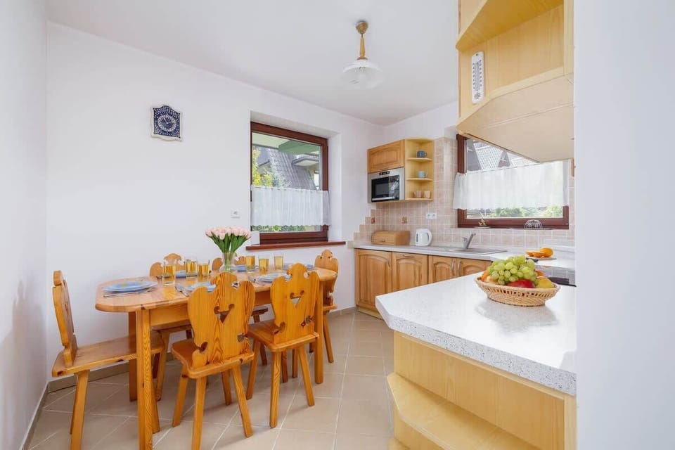 The kitchen's traditional design includes all necessary cookware and utensils. 
