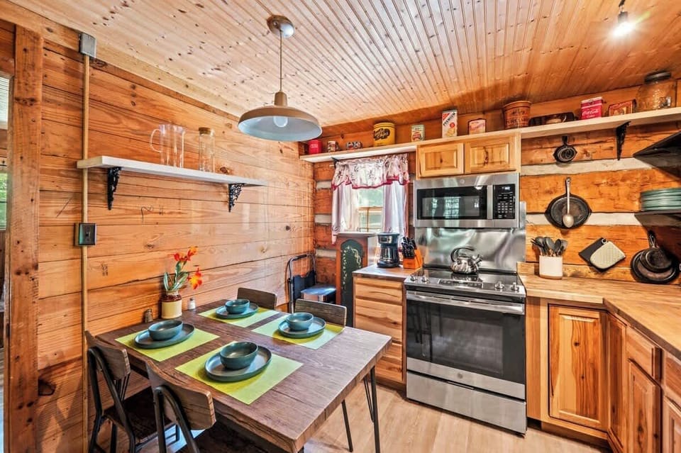 Retro tins, open shelving, and cabin warmth set the perfect kitchen scene.