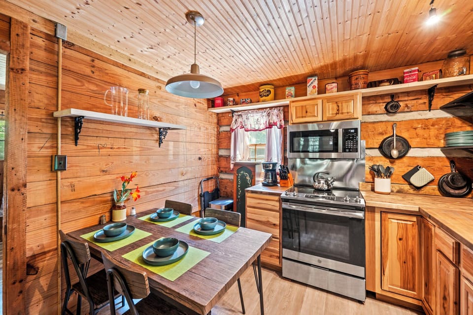 Retro tins, open shelving, and cabin warmth set the perfect kitchen scene.