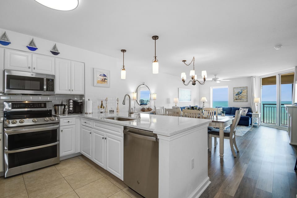 Your stunning oceanfront kitchen opens to breathtaking sea views, where cooking becomes pure joy with modern appliances and coastal charm.