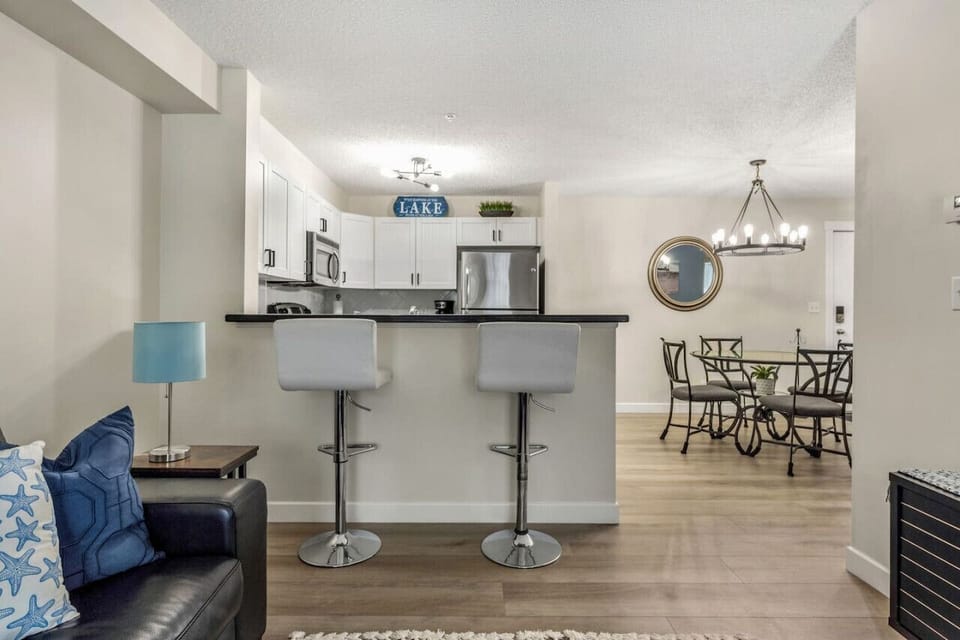 Dining area with seating for 6 at the table and 2 at the island.