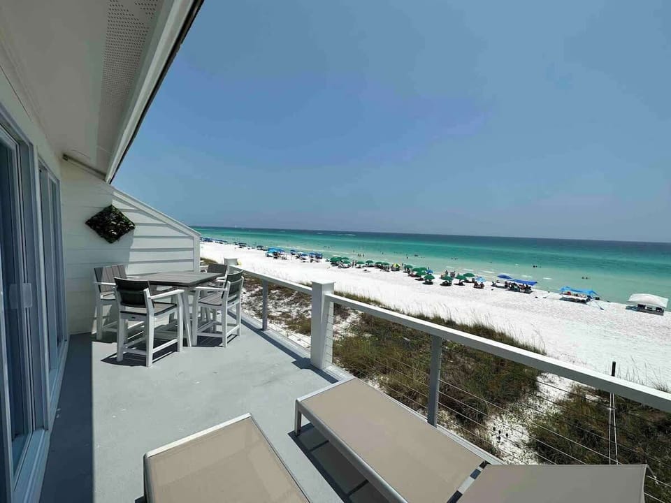 View from Master bedroom deck.  High top table for 4 plus 2 deck lounge chairs.