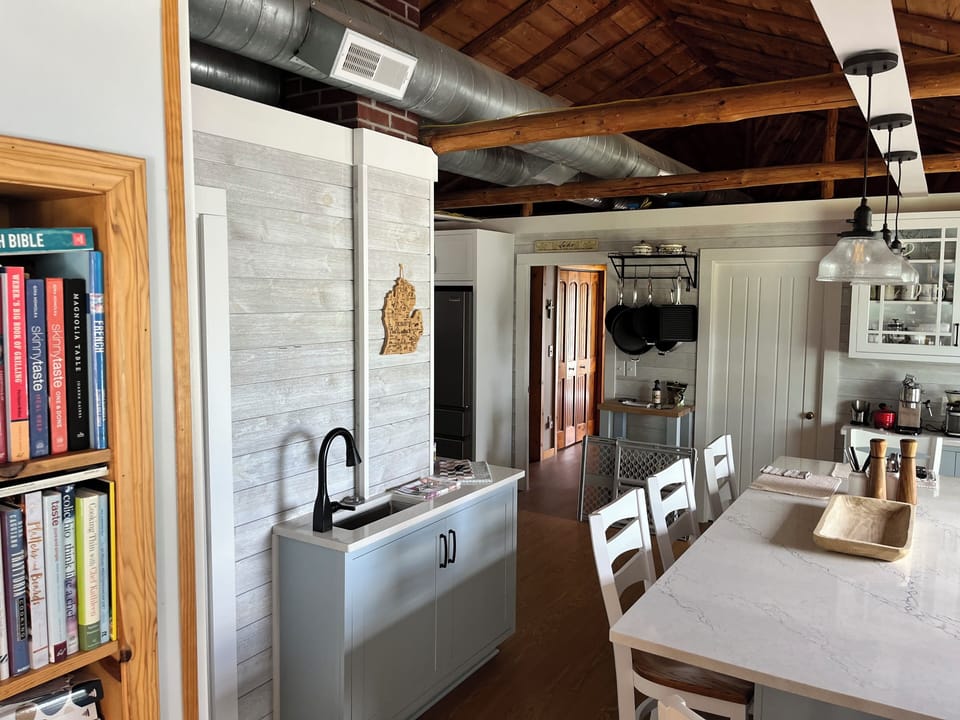 8 person granite table with wet bar and panoramic views of Long Lake. 