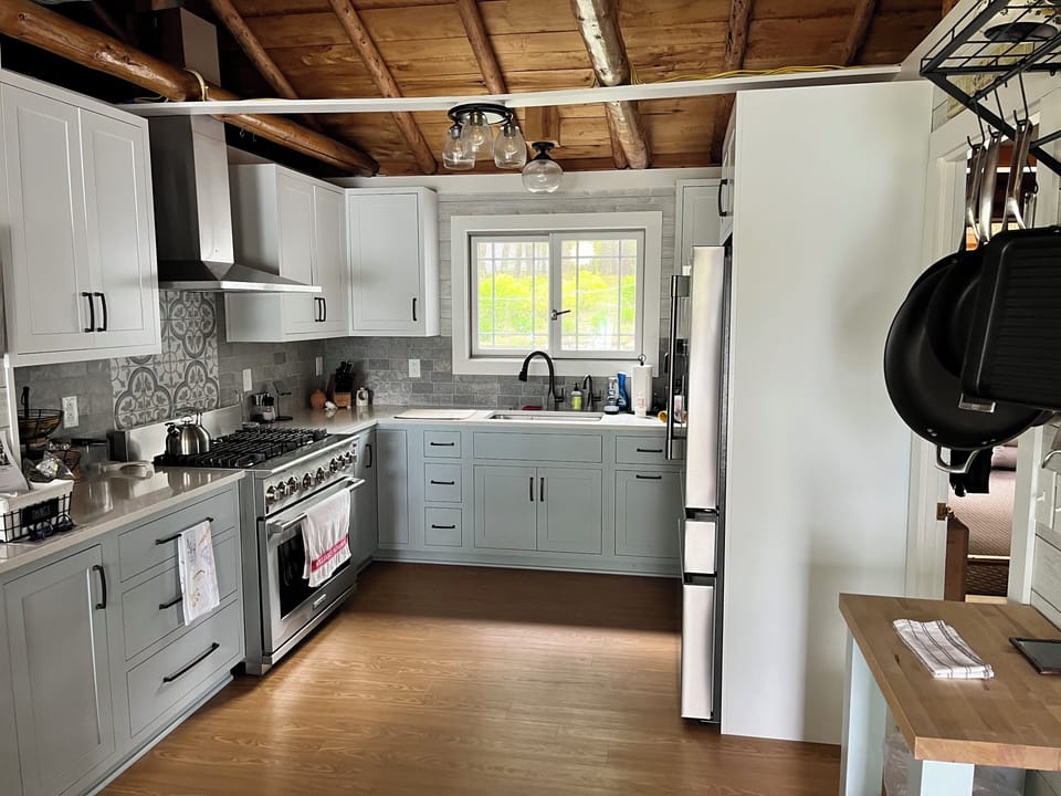 Chefs Kitchen with garden and lake views.  Table setting for 15ppl provided.