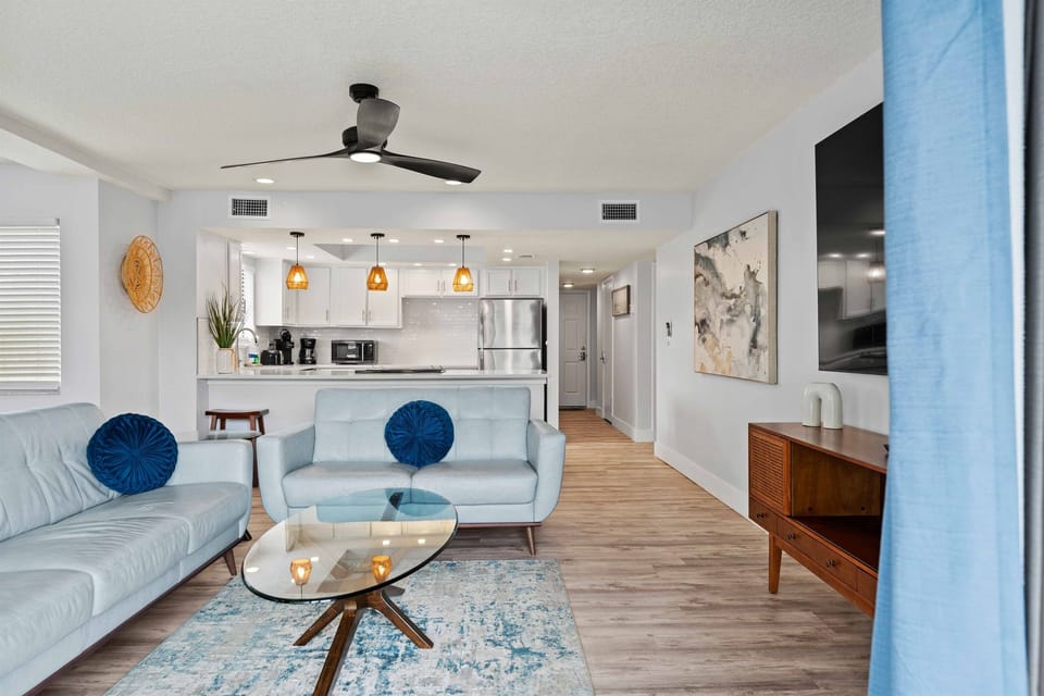 Enjoy an airy, modern living area with updated furnishings, coastal accents, and an inviting layout perfect for lounging with family and friends.