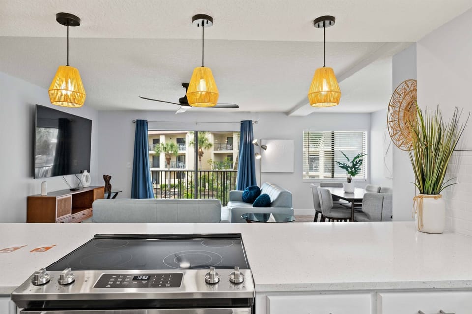 Chef-Friendly Kitchen & Cozy Living View flat-top range, updated appliances, and stylish lighting create the perfect space to cook, dine, and gather.