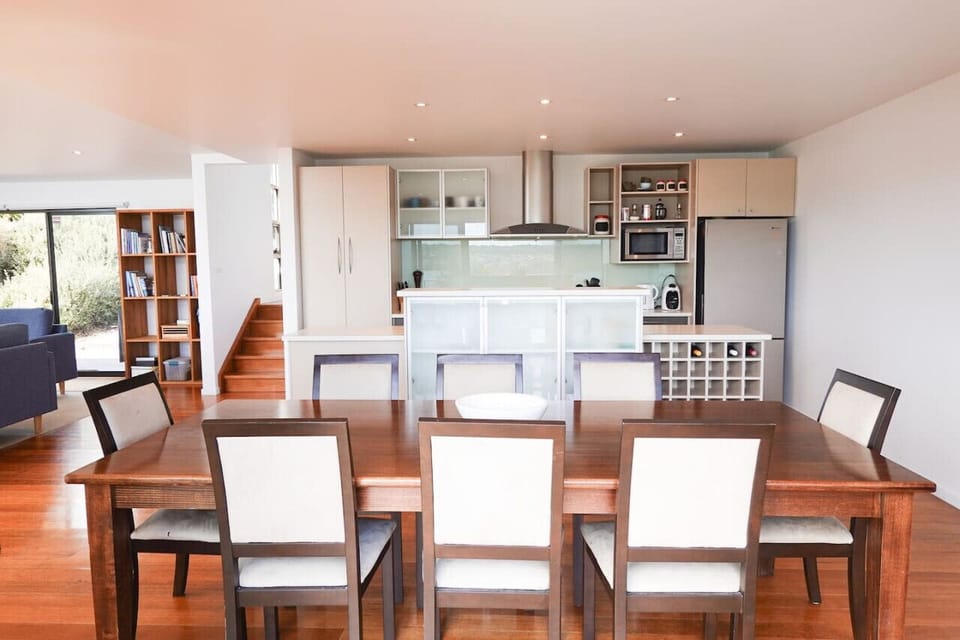 Large dining room table in the open plan living area and kitchen