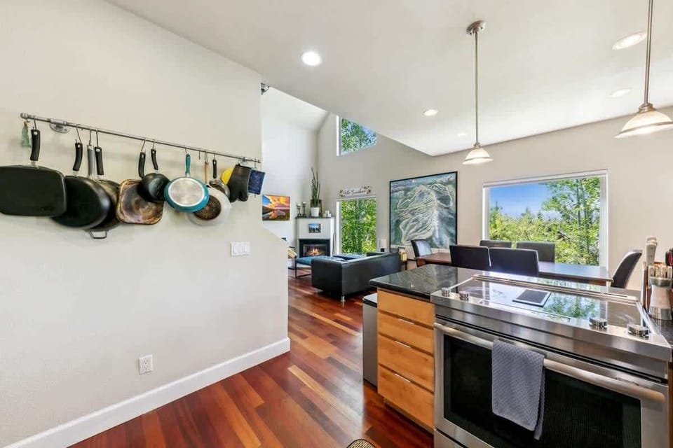 Spacious mountain kitchen with electric range, stainless steel appliances, ample cabinetry and breakfast-bar seating, providing a convenient cooking and gathering space in this South Lake Tahoe vacation home.