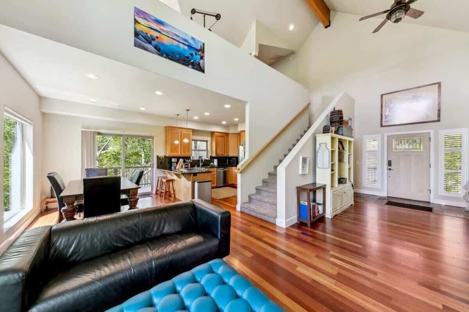 Open living area in this South Lake Tahoe cabin with comfortable seating, large windows and natural light, showcasing the spacious layout designed for families and groups to spread out.