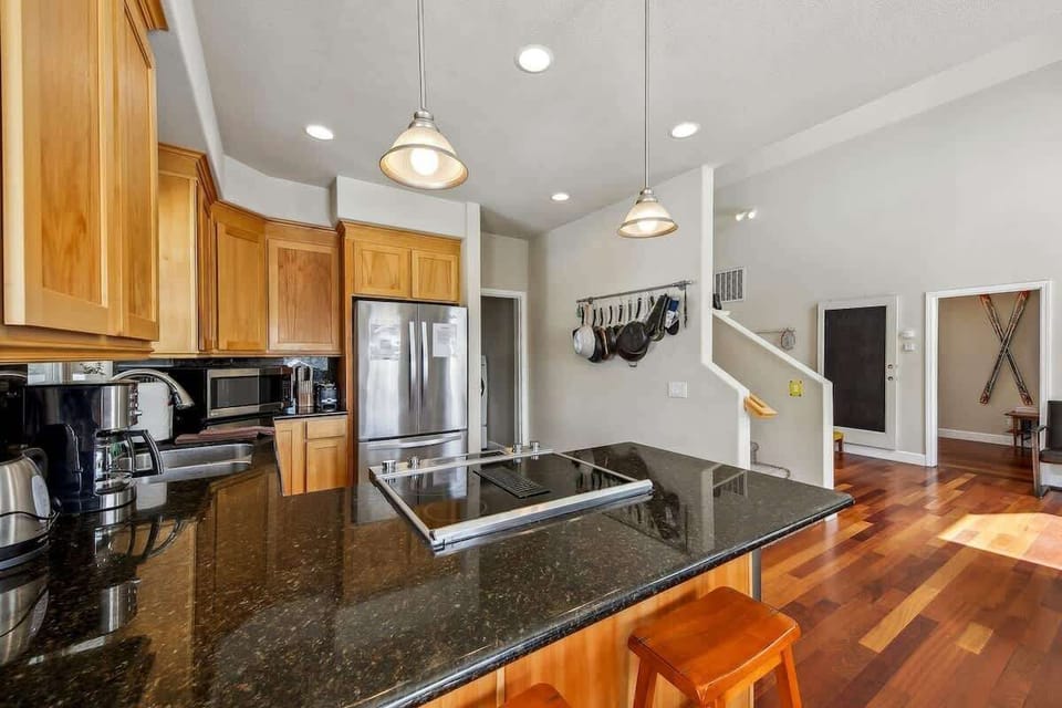 Fully equipped South Lake Tahoe cabin kitchen with range, stainless steel appliances, cookware, bakeware, dinnerware and utensils, providing everything needed to prepare family meals and enjoy a comfortable Tahoe stay.
