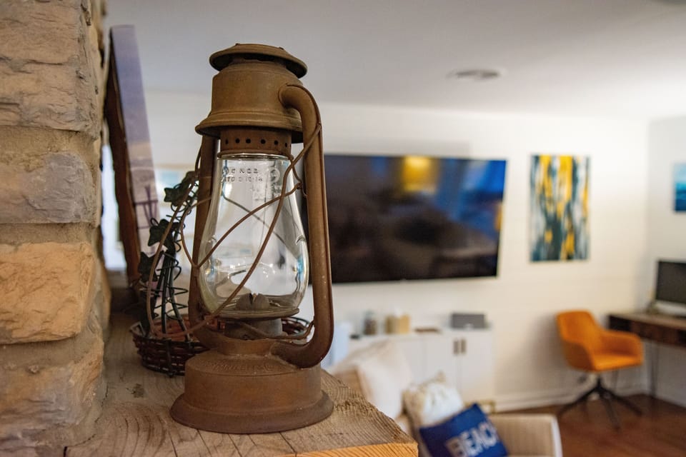 Rustic lantern detail with cozy living room and modern entertainment space