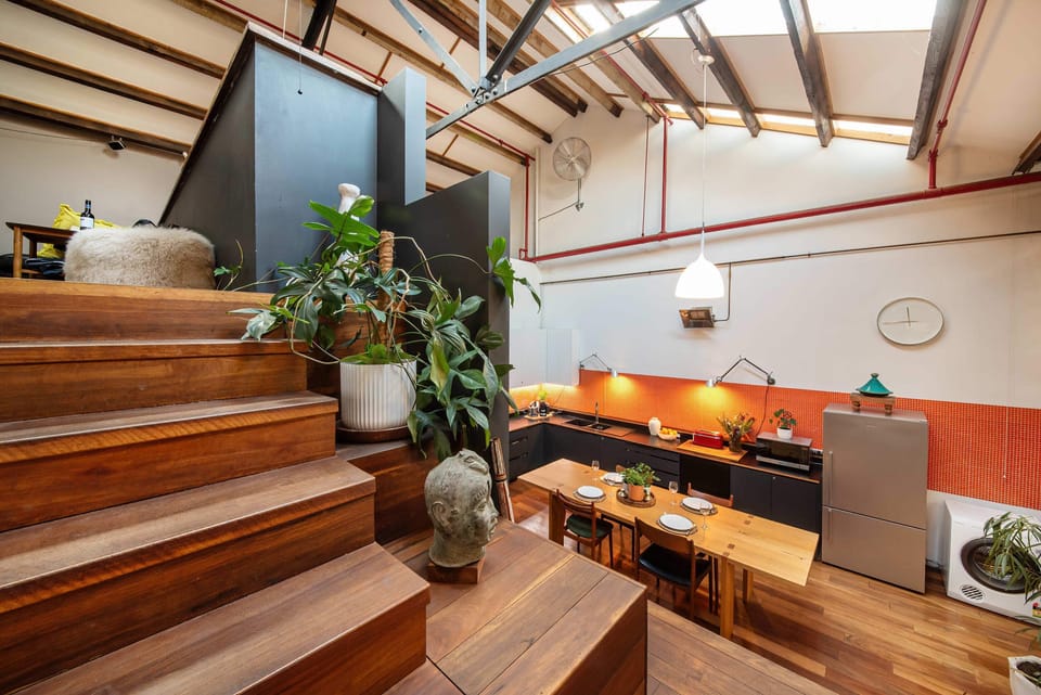 Stairs down to kitchen from upper mezzanine level