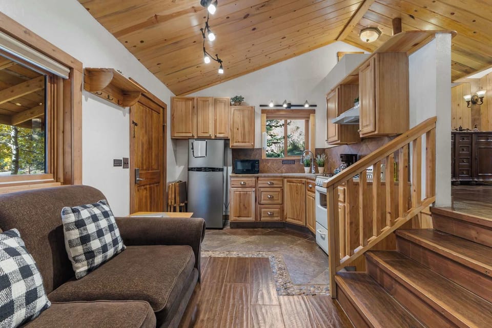 The full kitchen and living room are next to each other on the first level