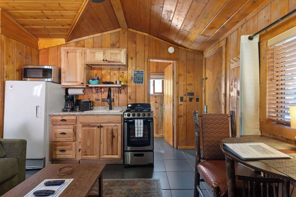The bathroom is by the front door and the kitchen.