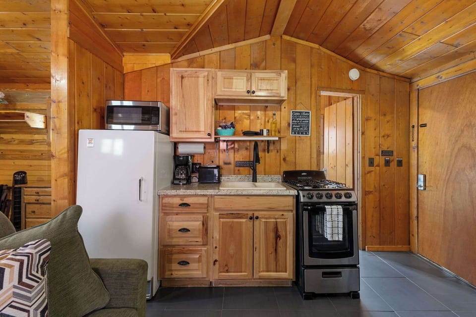 The kitchenette has a small oven, refrigerator, toaster, microwave and coffee maker. 