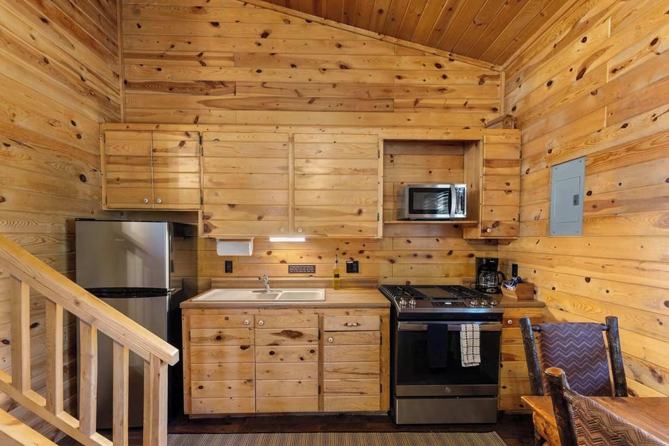 The kitchen has new, stainless steel appliances and a full-sized stove and refrigerator. 