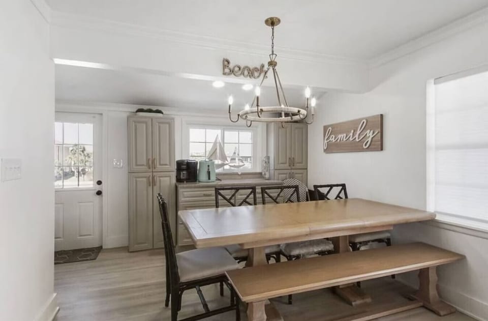 Gather around this charming farmhouse dining space where your family meals become treasured memories beneath warm lighting.