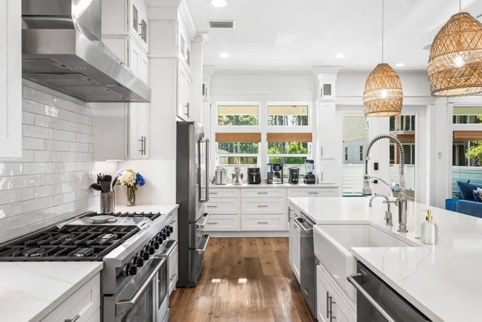 Your spacious gourmet kitchen awaits with gleaming counters, professional appliances, and warm pendant lighting for memorable meal prep.
