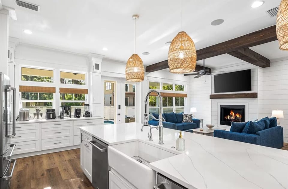 Unwind in your open-plan sanctuary where the gourmet kitchen flows seamlessly into the cozy living area with crackling fireplace.